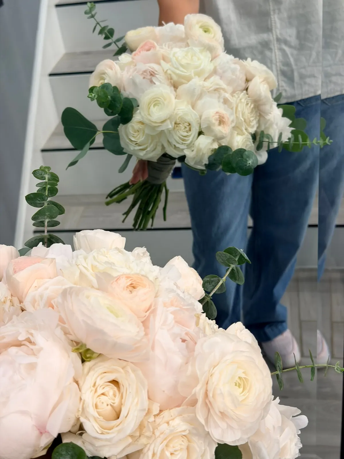 Two hand-tied ivory and blush bouquets with eucalyptus