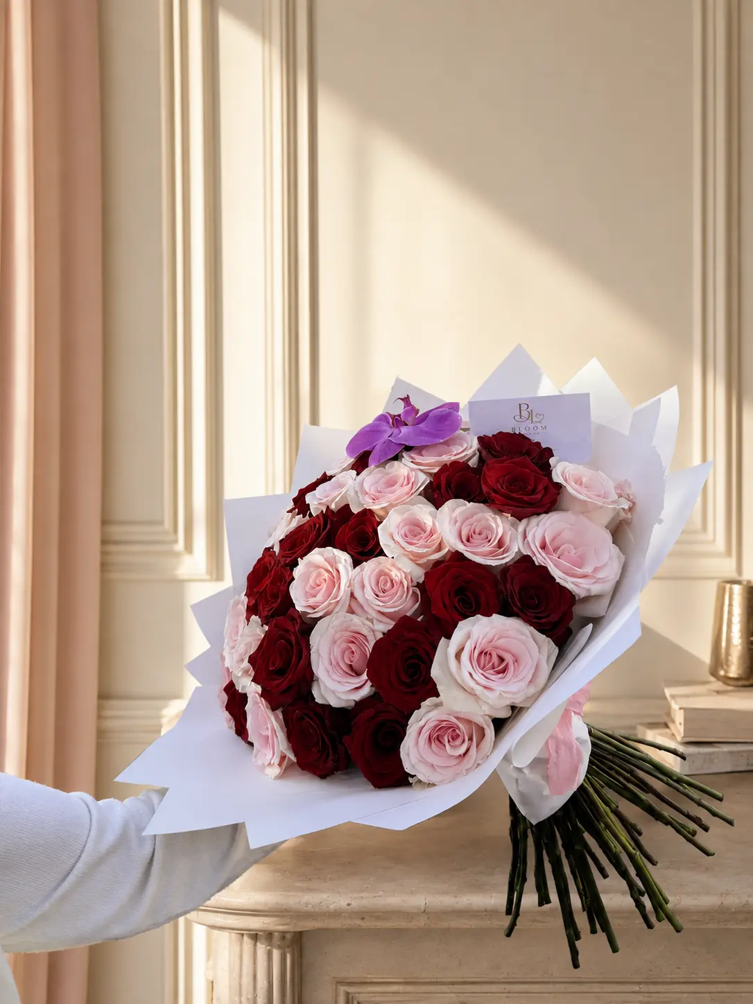 Signature Rose Bouquet of pink and red premium roses with an orchid accent, wrapped in white luxury paper