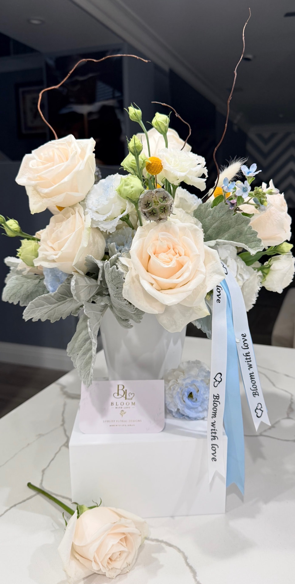 Something Blue elegant garden arrangement with ivory, white and soft blue blooms in a modern white vase
