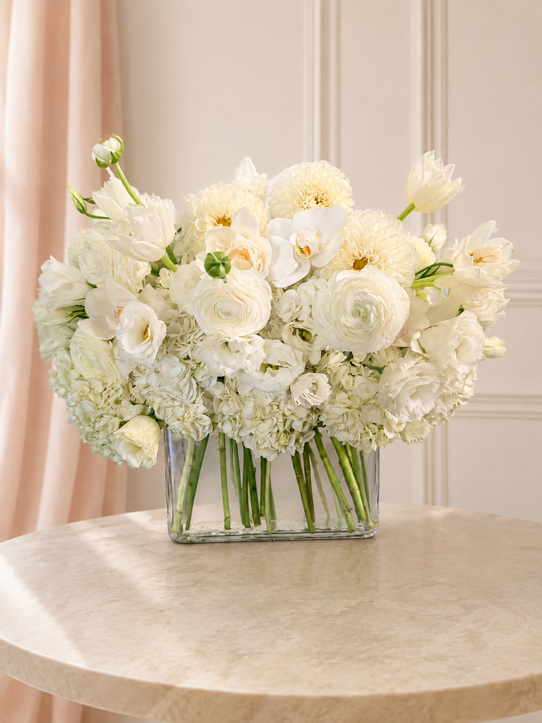 Ivory Serenity arrangement of premium white and ivory flowers with elegant orchids in a low rectangular glass vase