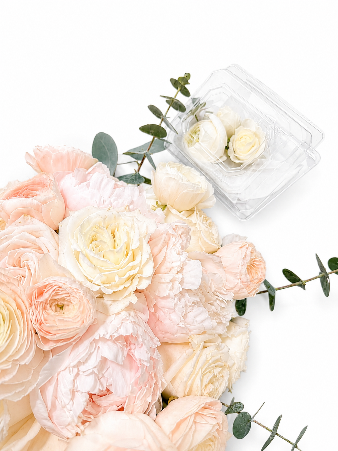 Blush and ivory garden roses, ranunculus and eucalyptus flat-lay arrangement with extra white roses, crafted by Bloom With Love in Santa Clarita, CA