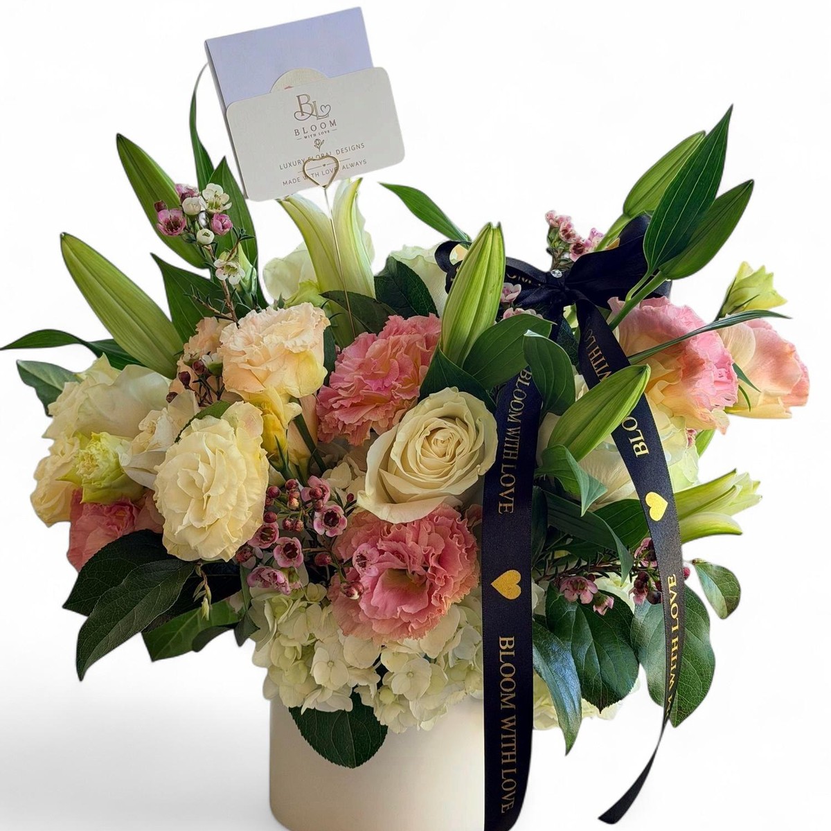 Blush Garden Vase arrangement with white roses, pink carnations and lilies in a white ceramic vase