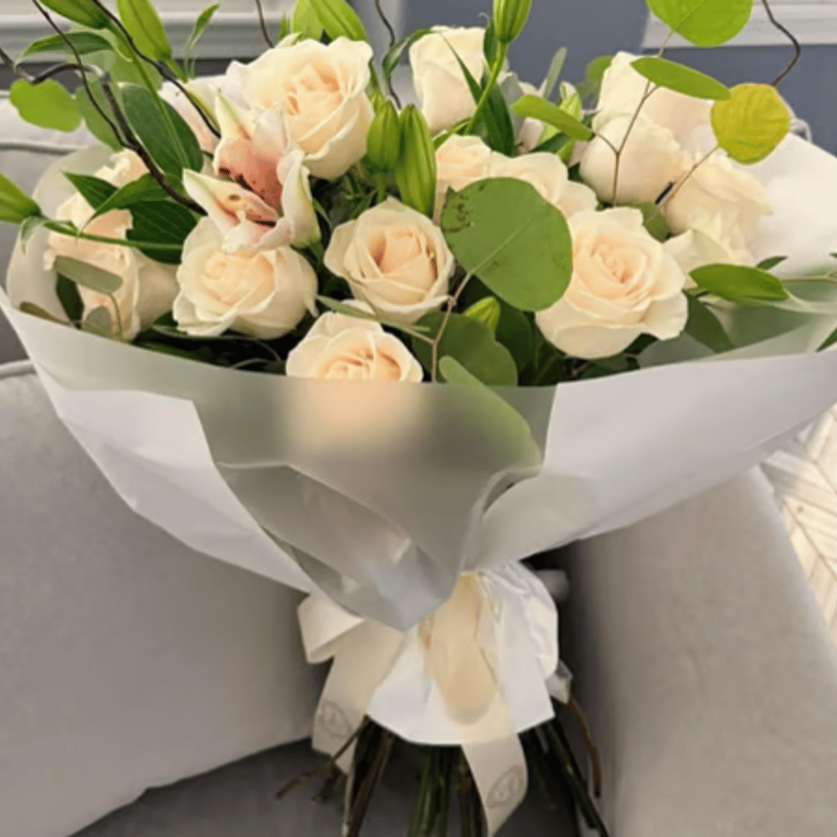 Luxury Rose and Lily bouquet of twenty-four roses hand-wrapped in luxury paper