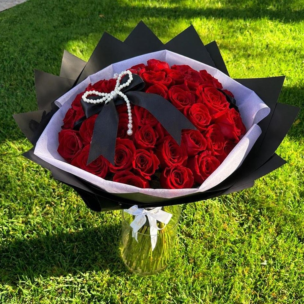 Bouquet of fifty premium long-stem red roses wrapped in black and white paper